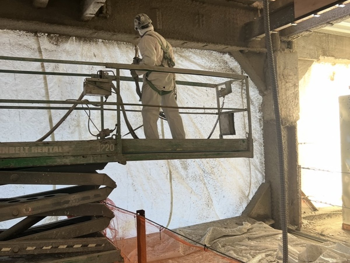 PAL worker spraying fireproofing from a scissor lift