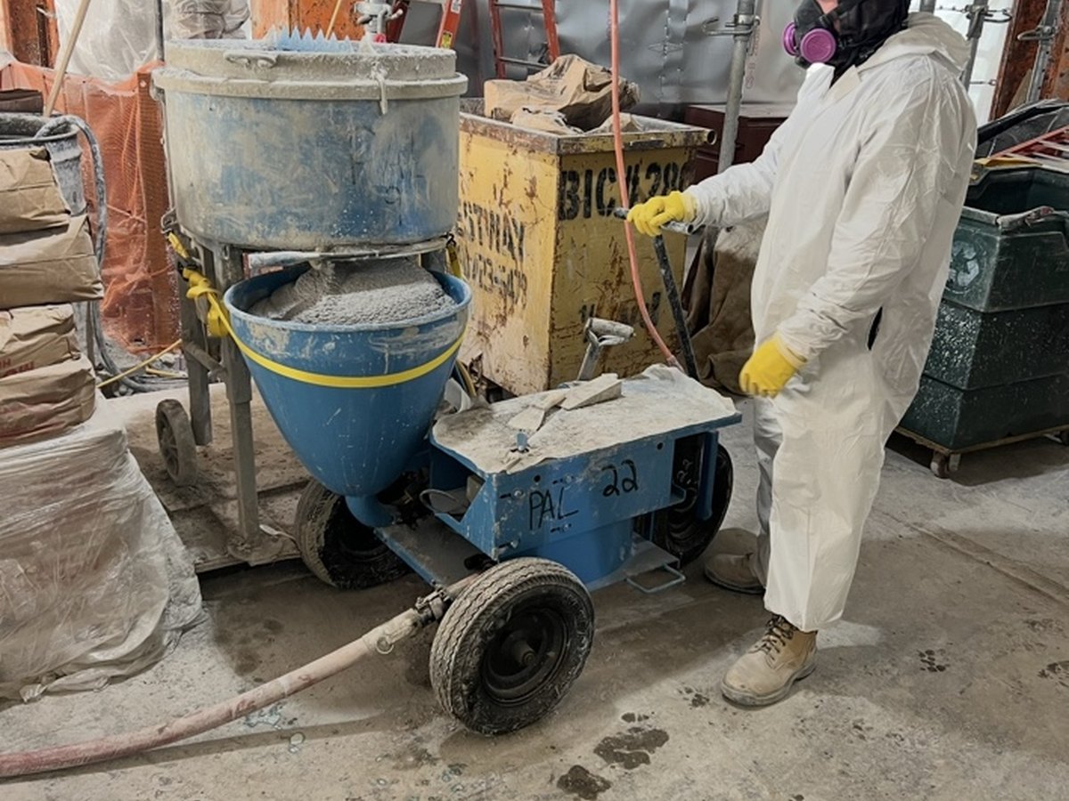 PAL worker using fireproofing equipment on site